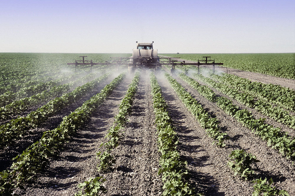 Field being sprayed with pesticides